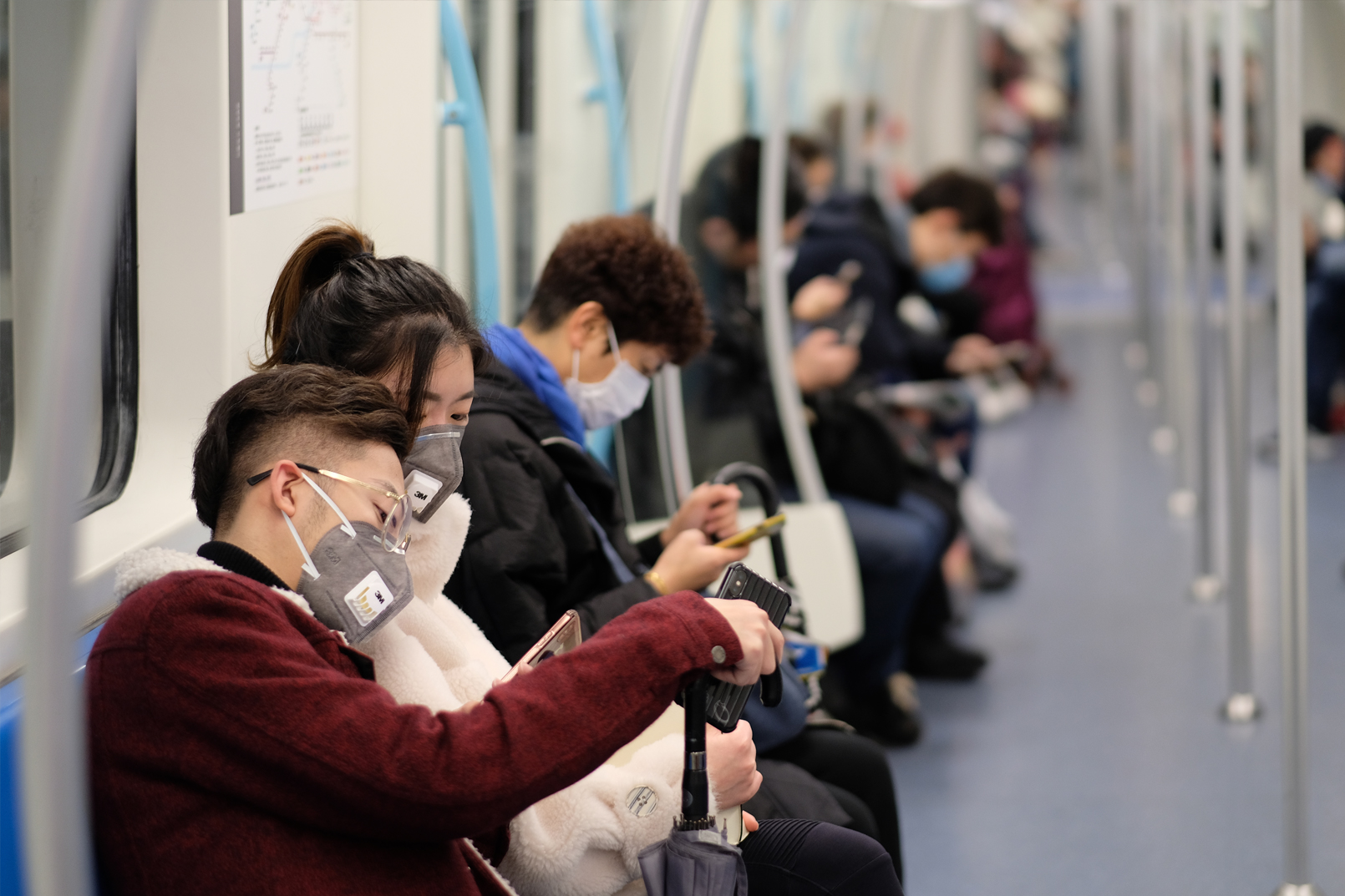 Masked passengers on subway train